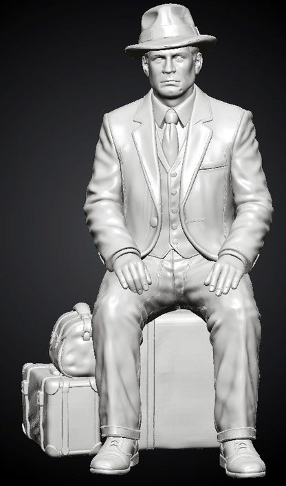 MM1494 Seated Gentleman in Suit and Fedora with Stacked Luggage
